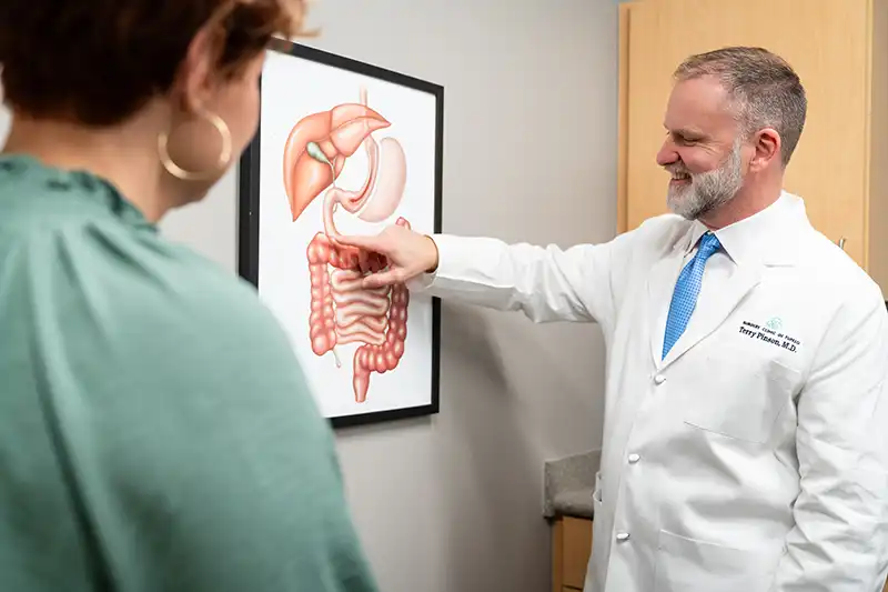 Dr. Terry Pinson of Surgery Clinic of Tupelo explains bariatric surgery to a patient.