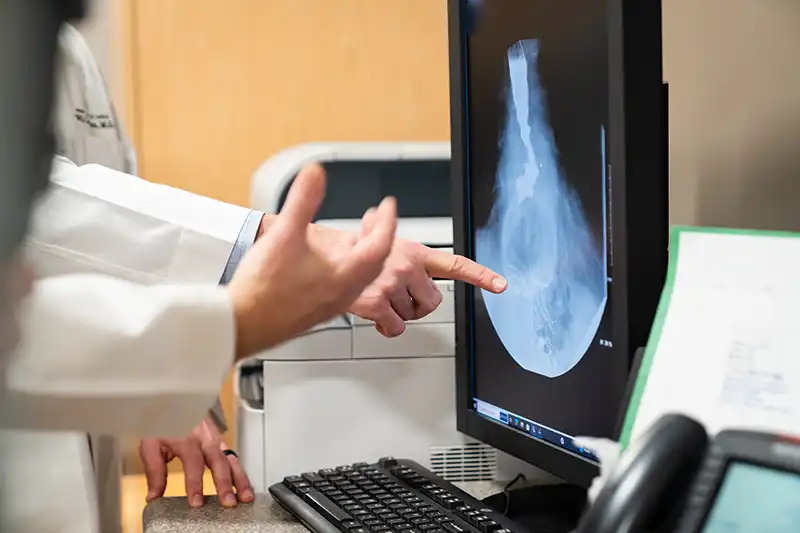 Bariatric surgeons examine the results of a weight-loss patient’s imaging scan.