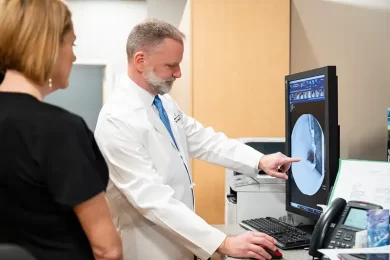 Dr. Terry Pinson examines a patient’s imaging scan at Surgery Clinic of Tupelo in Northern Mississippi.